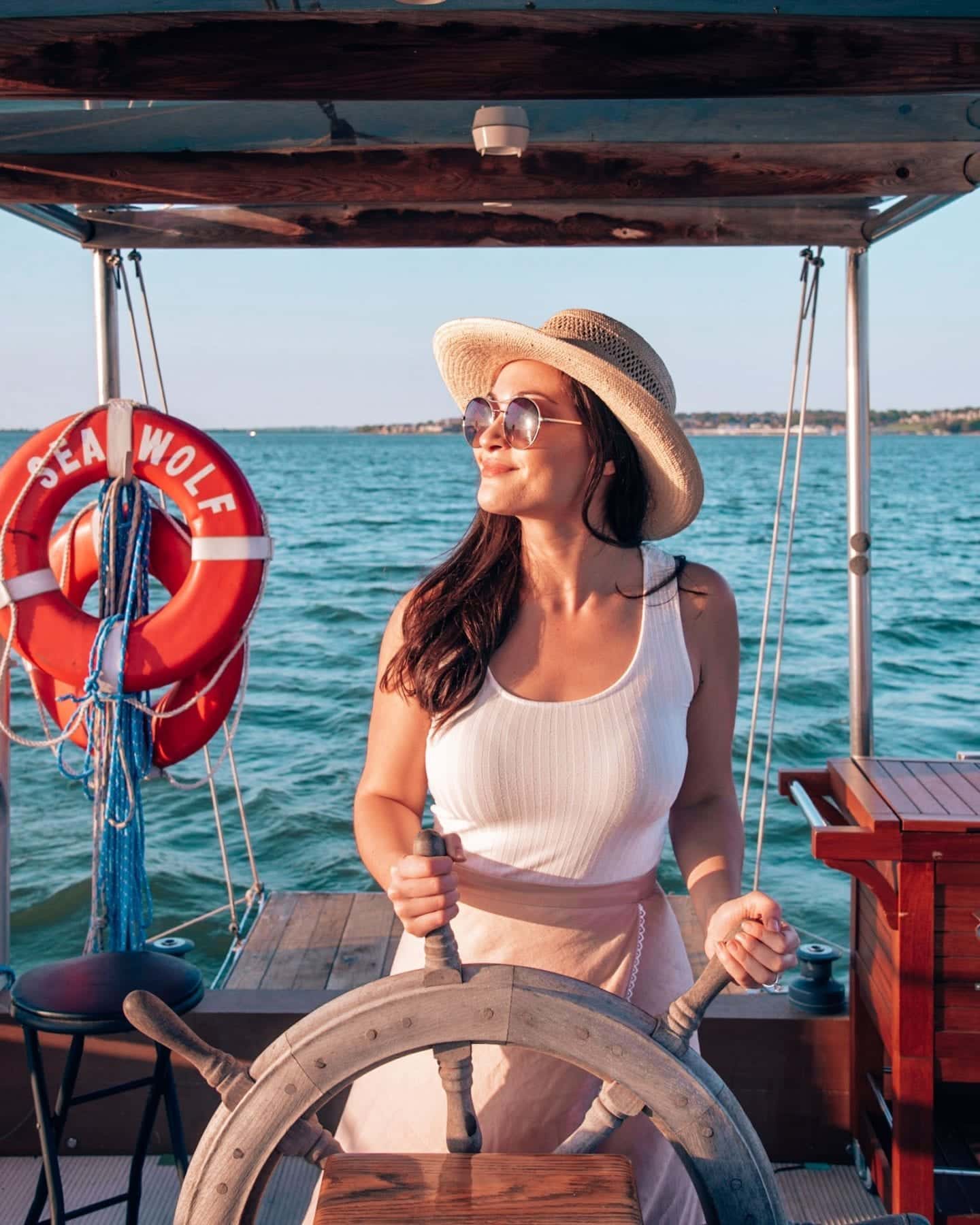 girl at wheel of boat