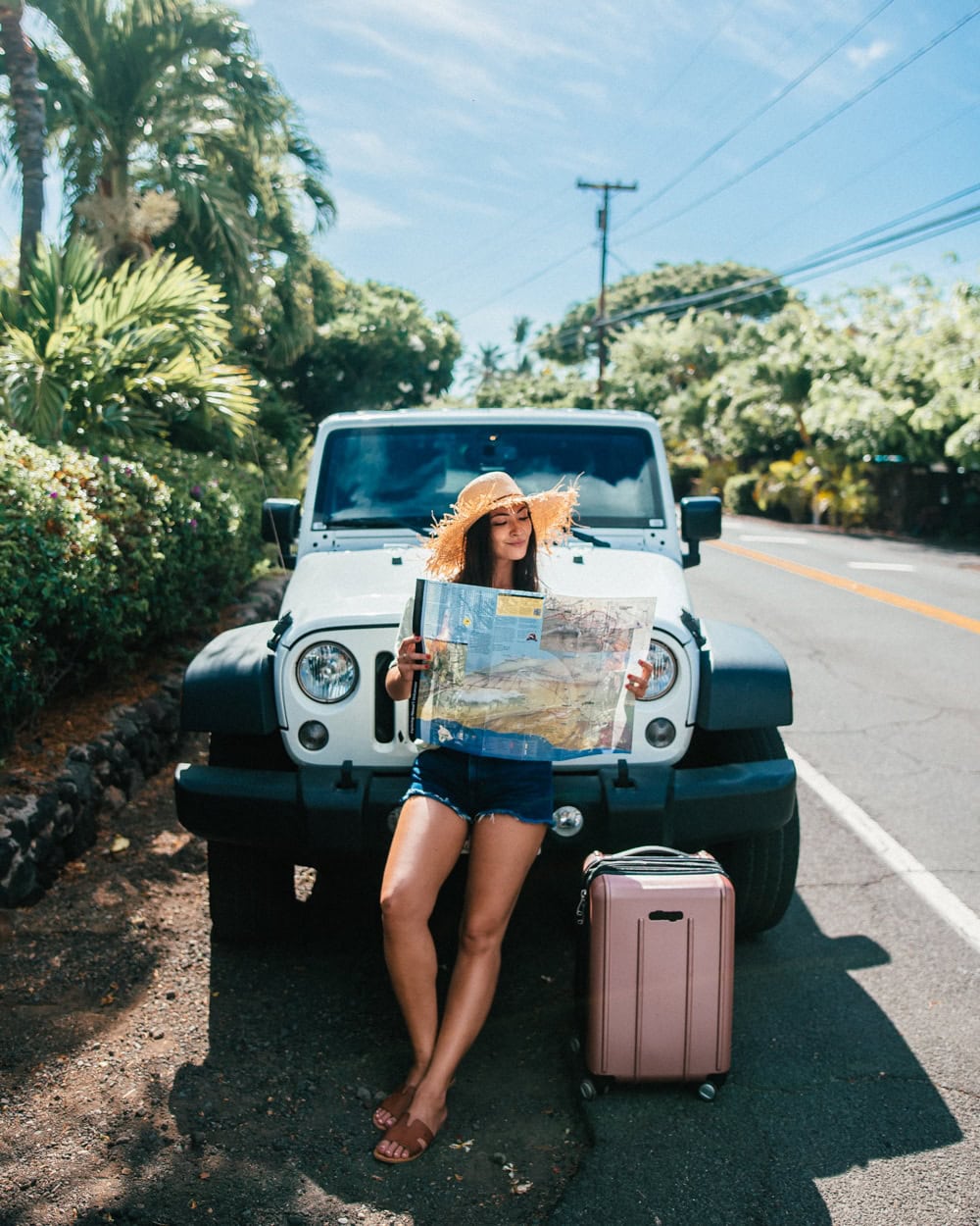 girl reading map jeep suitcase hawaii