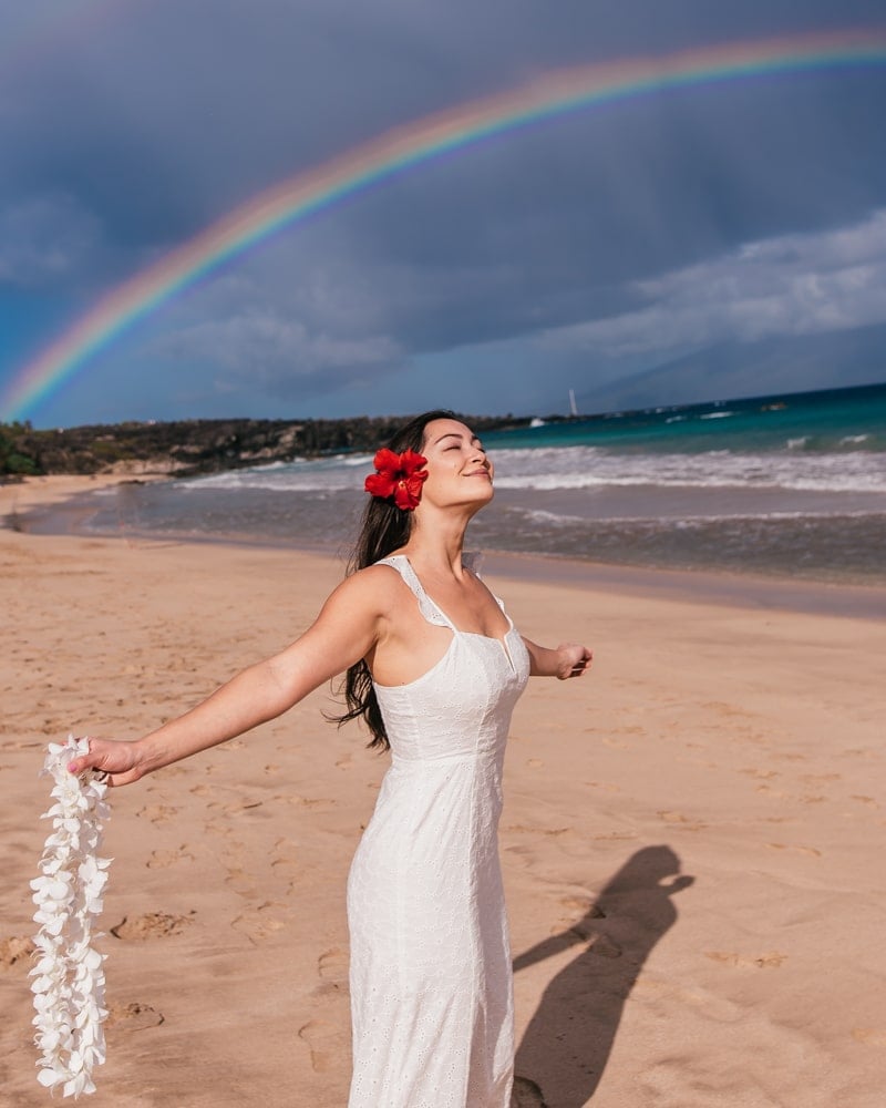 girl in front of rainbow in Maui