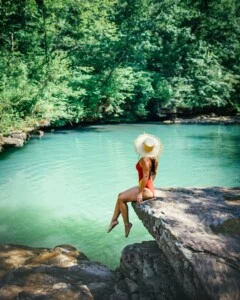 Girl Sitting At Blue Hole Arkansas