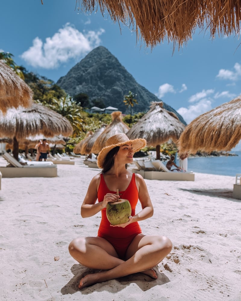girl drinking coconut water on the beach