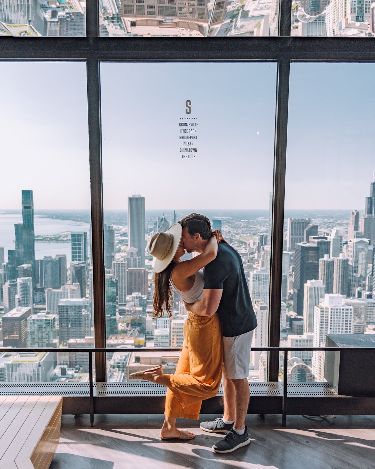 Couple kissing in front of downtown Chicago at 360 Chicago