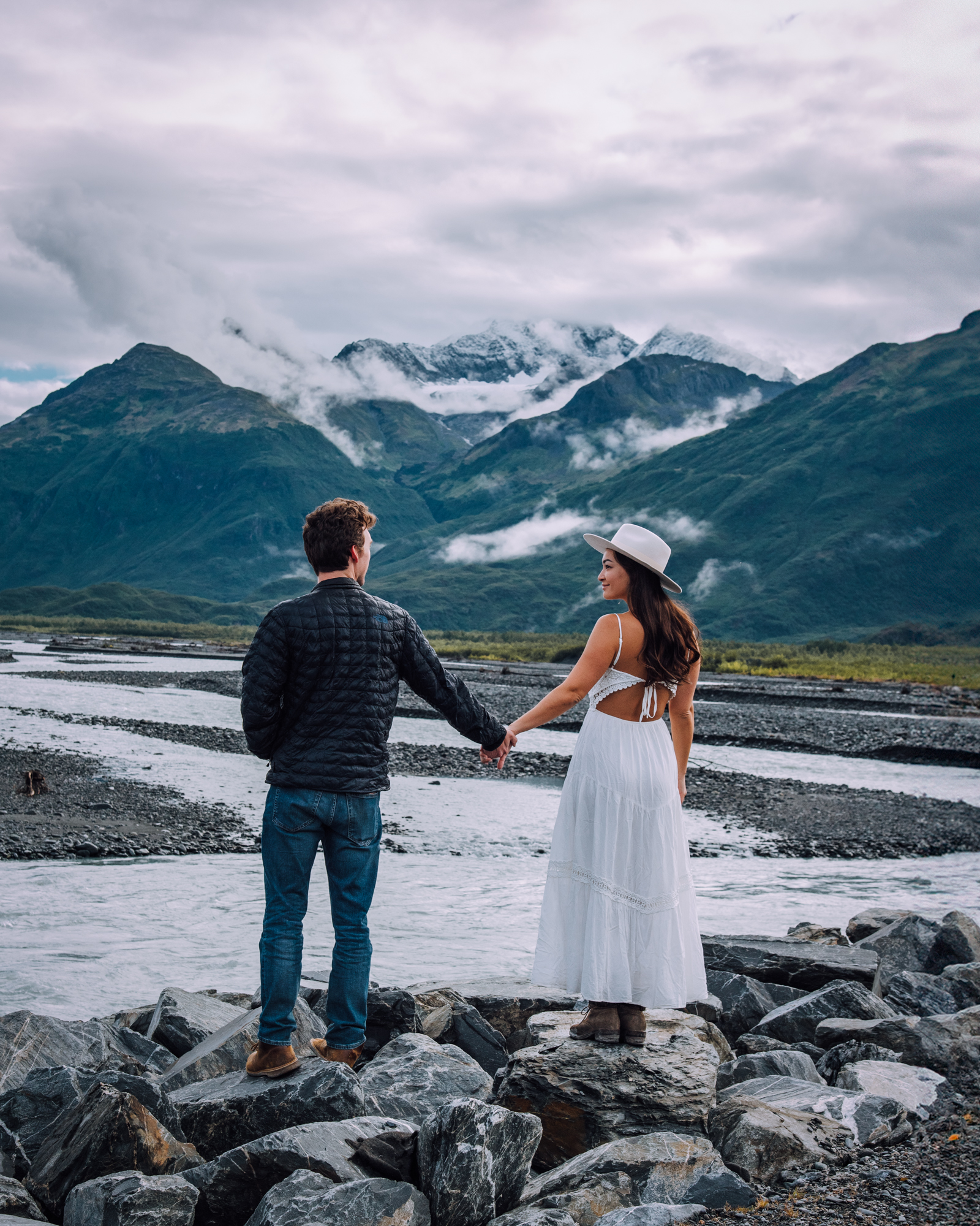 Couple holding hands looking at each other in Valdez, Alaska