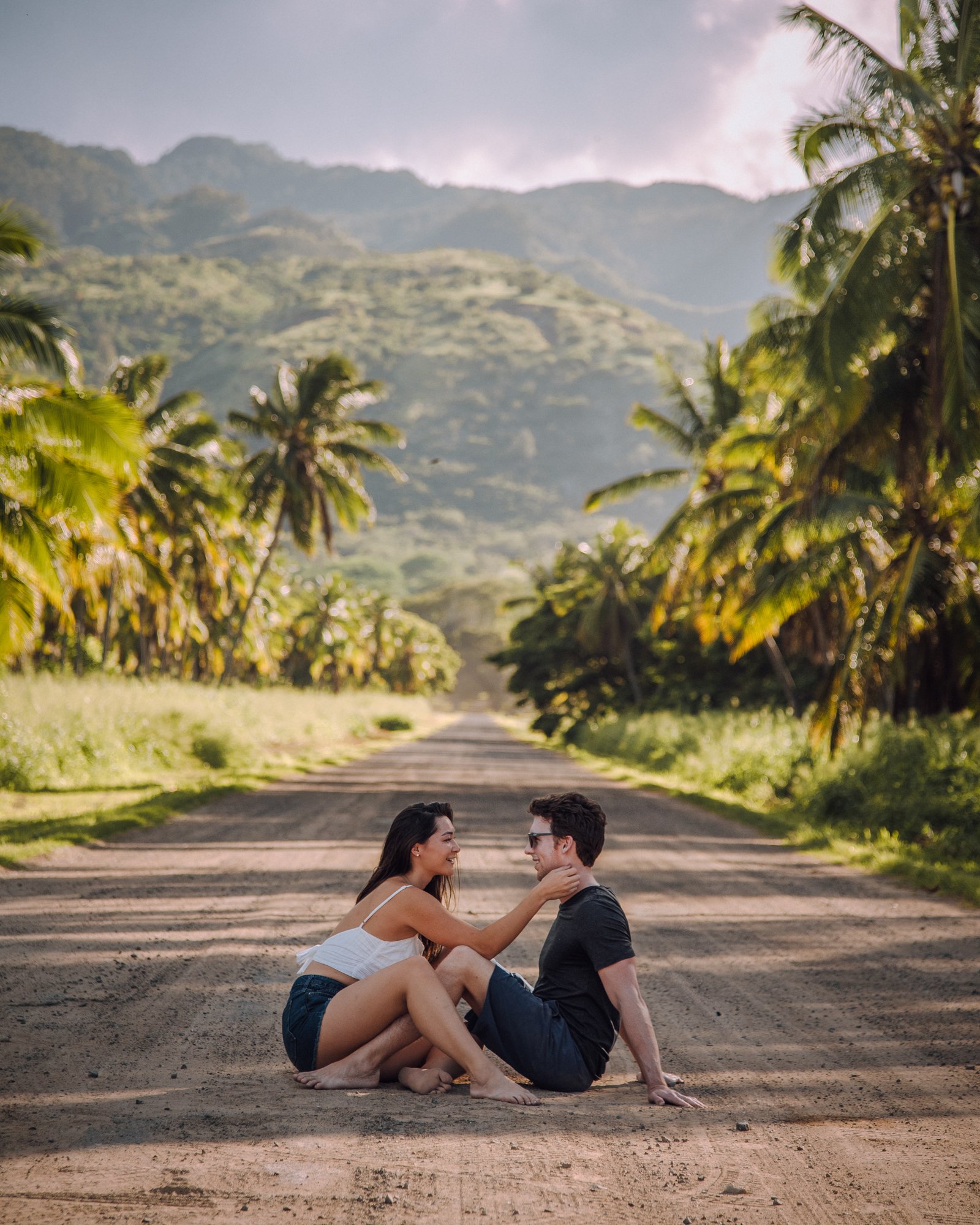 Couple sitting on a road in Oahu at Dillingham Ranch