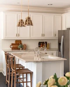 Wood Grounds An Otherwise Light And White Kitchen With Taj Mahal Quartzite Kitchen Countertops and Tongue and Groove Backsplash