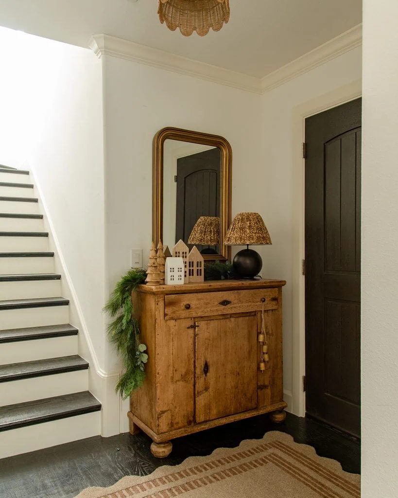 Faux cedar garland draped across an antique credenza with Christmas decorations